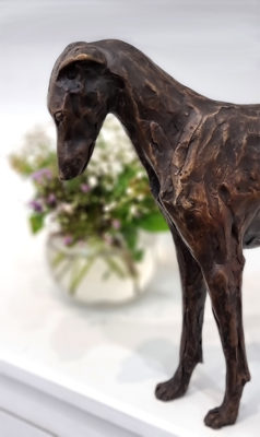 Stuart Anderson at Norton Way Gallery Hertfordshire. This beautiful foundry bronze sculpture from Stuart Anderson depicts a sighthound, which could be a greyhound or lurcher, standing with its neck arched.