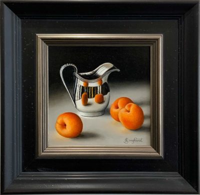 This original oil painting from Anne Songhurst, depicts a silver jug with Apricots. It is framed in a dark wooden frame with silver adetail on the inner rim. It is exhibited at Norton Way Gallery Hertfordshire