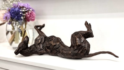Stuart Anderson at Norton Way Gallery Hertfordshire. This beautiful foundry bronze sculpture from Stuart Anderson depicts a sighthound, which could be a greyhound or lurcher, rolling on its back.