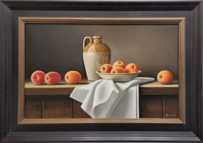 This beautiful Anne Songhurst, original oil painting is exhibited at Norton Way Gallery. It depicts a group of apricots, linen napkin, dish and a stoneware flagon. The stunning composition is typical of an Anne Songhurst realist painting. It is exhibited at Norton Way Gallery Hertfordshire. Framed in a rich darkest brown black frame with dark gold inner.
