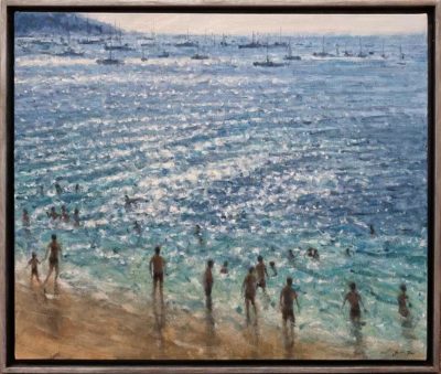 Justin Tew at Norton Way Gallery, Hertfordshire. This original artwork by British artist, Justin Tew is painted in oils. It depicts a view of the beach, with boats and ships on the horizon. This original painting is framed in a gray burnished wood, deep frame.