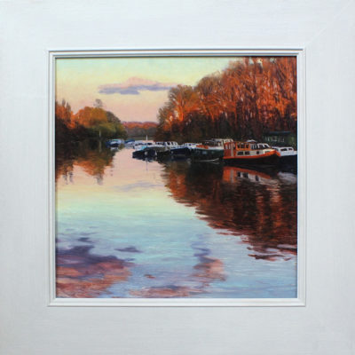 Rosemary Lewis at Norton Way Gallery, Hertfordshire. This original artwork by British artist, Rosemary Lewis is painted in oils. It depicts a river scene with a beautiful orange sunset. This original painting is framed in a hand painted, off white frame.