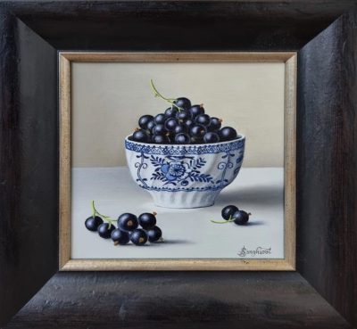 Anne Songhurst Art at Norton Way Gallery Hertfordshire. This beautiful oil painting is an original artwork by British artist Anne Songhurst. It is a still life painting, depicting a blue and white antique bowl with blackcurrants. It is framed in a dark wooden frame with a gold slip.
