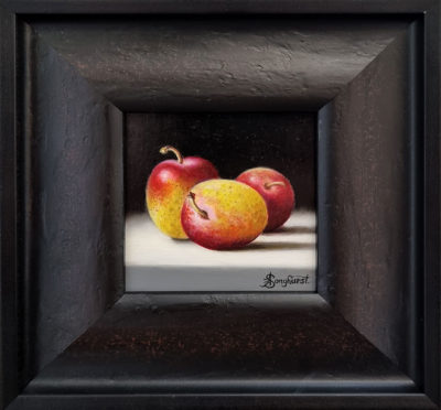 Anne Songhurst Art at Norton Way Gallery Hertfordshire. This beautiful oil painting is an original artwork by British artist Anne Songhurst. It is a still life painting, depicting three plums. It is framed in a dark wooden frame with a gold slip.
