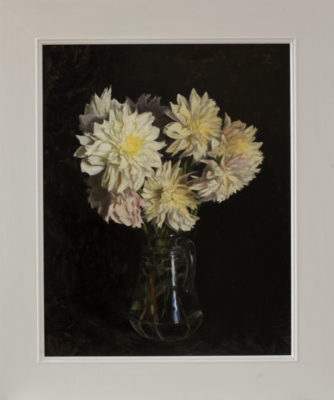 Rosemary Lewis at Norton Way Gallery, Hertfordshire. This original artwork by British artist, Rosemary Lewis is painted in oils. It depicts a bunch of cream coloured Dahlias in a glass jug. This original painting is framed in a hand painted, off white frame.