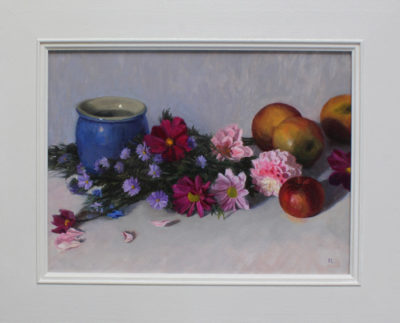 Rosemary Lewis at Norton Way Gallery, Hertfordshire. This original artwork by British artist, Rosemary Lewis is painted in oils. It depicts a blue vase, strewn flowers and apples. This original painting is framed in a hand painted, off white frame.
