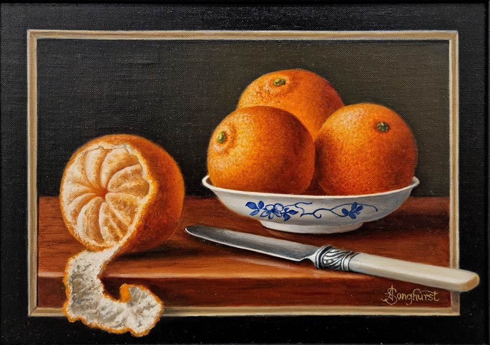 Anne Songhurst Art at Norton Way Gallery Hertfordshire. This beautiful oil painting is an original artwork by British artist Anne Songhurst. It is a still life painting, depicting four oranges, a small dish and a knife. Both the knife and orange peel are partly painted in a tromp l'oeil style.