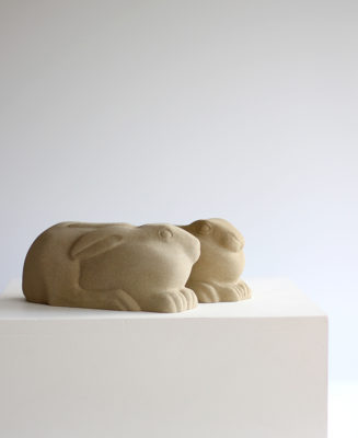 Jennifer Tetlow sculpture at Norton Way Gallery Hertfordshire. This beautiful stone carving, from Jennifer Tetlow is carved from Yourkstone. It depicts a symbolic, two beautiful small hares or leverets, huddled down .