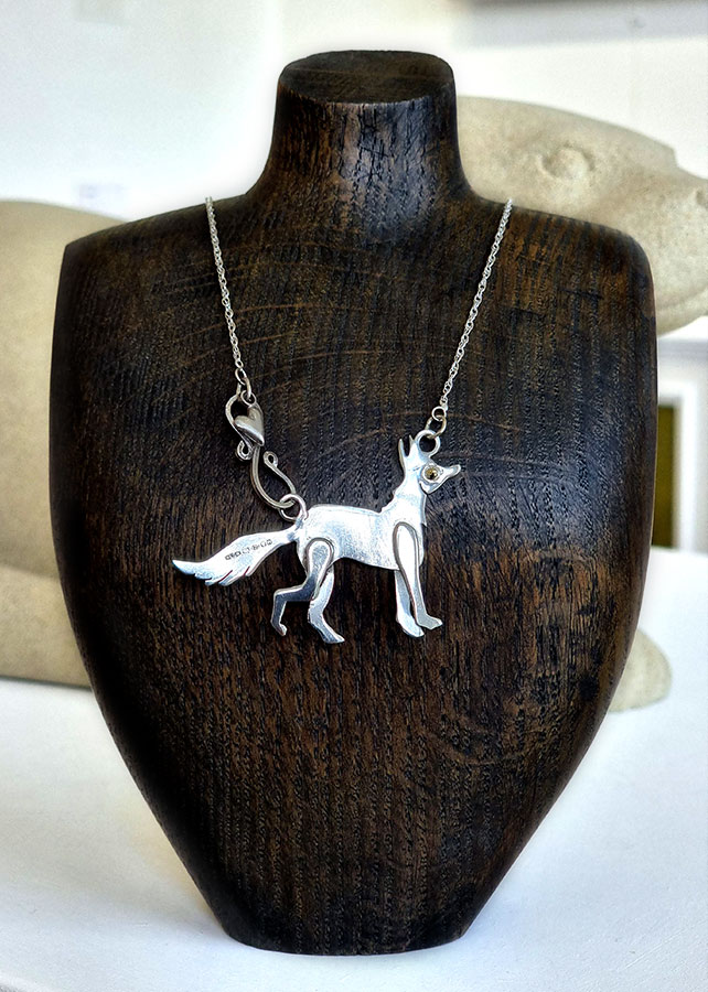 Lou Shotter at Norton Way Gallery, Hertfordshire. This original artwork by British artist, Lou Shotter is created in Stirling Silver. It is a pendant depicting a silver fox. A piece of jewellery.