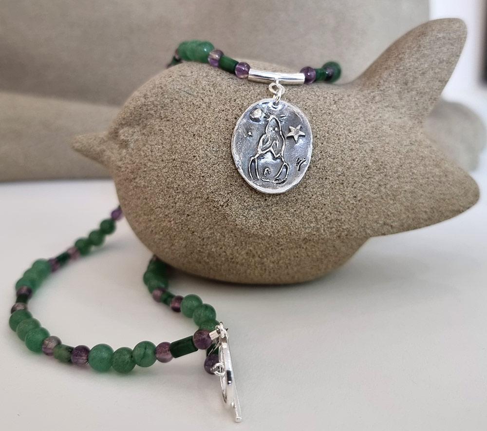 Sarah Cain at Norton Way Gallery, Hertfordshire. This original artwork by British artist, Sarah Cain is created in fine silver. It is a beautiful pendant, comprising fine silver with amethyst, Aventurine and Nephrite Jade. It depicts a star and moon gazing hare. A piece of jewellery.