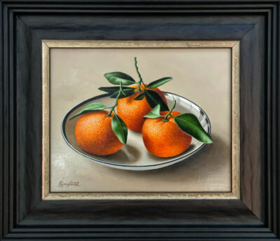 Anne Songhurst Art at Norton Way Gallery Hertfordshire. This beautiful oil painting is an original artwork by British artist Anne Songhurst. It is a still life painting, depicting three mandarins in a white porcelain bowl. It is framed in a dark wood frame.