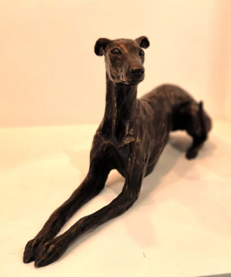 Stuart Anderson at Norton Way Gallery Hertfordshire. This beautiful foundry bronze sculpture from Stuart Anderson is an original artwork. It depicts a Whippet alert and laying upright.
