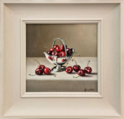 Anne Songhurst Art at Norton Way Gallery Hertfordshire. This beautiful oil painting is an original artwork by British artist Anne Songhurst. It is a still life painting, depicting a silver basket with cherries. It is framed in a white wood frame.