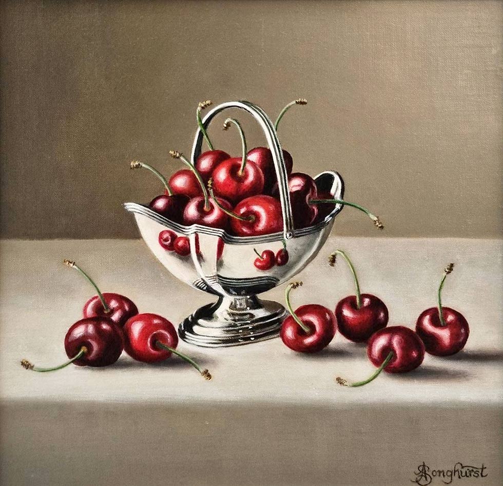 Anne Songhurst Art at Norton Way Gallery Hertfordshire. This beautiful oil painting is an original artwork by British artist Anne Songhurst. It is a still life painting, depicting a silver basket with cherries. It is framed in a white wood frame.