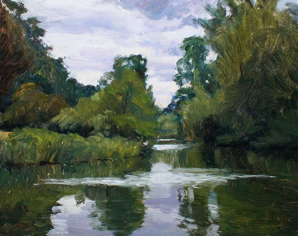 Rosemary Lewis at Norton Way Gallery, Hertfordshire. This original artwork by British artist, Rosemary Lewis is painted in oils. It depicts a beautiful lake reflecting the trees and bushes, that surround it. This original painting is framed in a hand painted, off white frame.