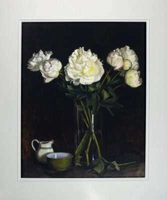 Rosemary Lewis at Norton Way Gallery, Hertfordshire. This original artwork by British artist, Rosemary Lewis is painted in oils. It depicts a large glass vase with white Peonies, and a small white jug and bowl. This original painting is framed in a hand painted, off white frame.