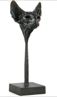 Andrzej Szymczyk sculpture at Norton Way Gallery Hertfordshire. This beautiful and unsual sculpture is created in foundry bronze by artist Andrzej Szymczyk. It depicts a powerful freestanding Spinx Cat Head on a pedestal in a dark bronze patina.