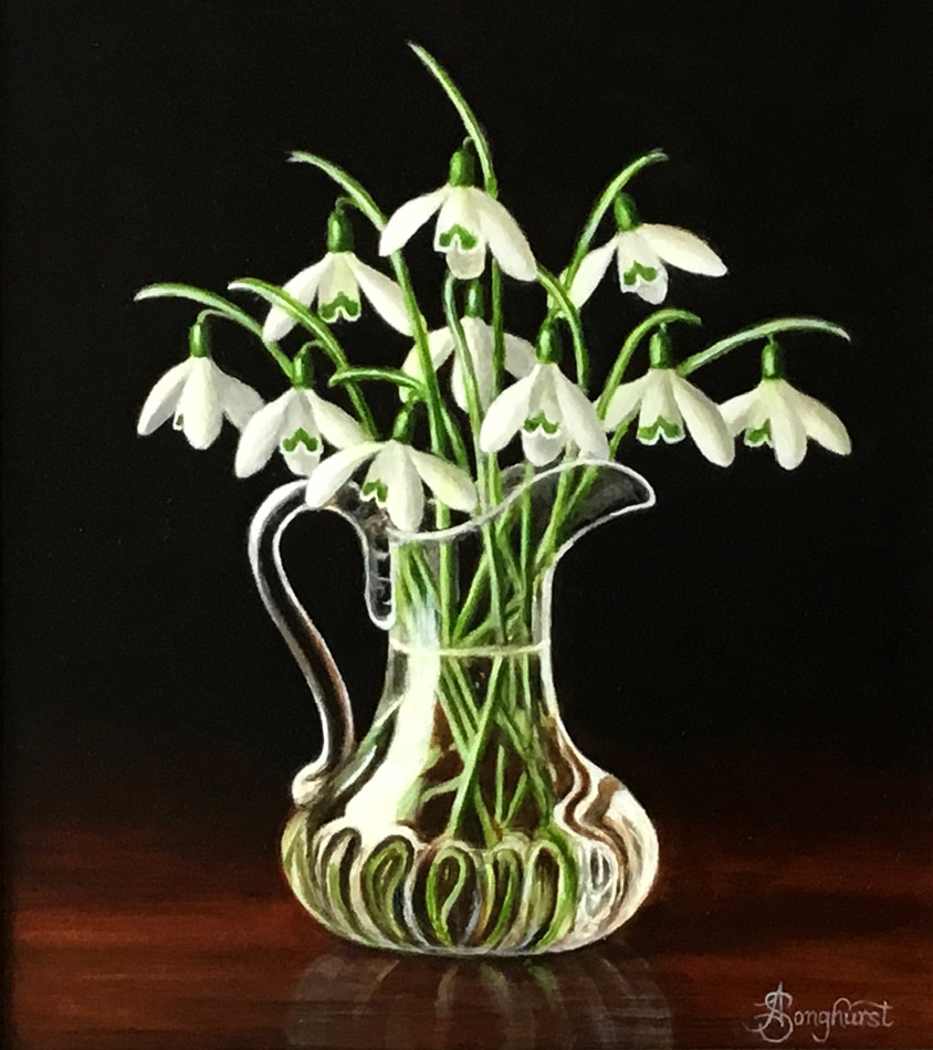 Anne Songhurst Art at Norton Way Gallery Hertfordshire. This beautiful oil painting is an original artwork by British artist Anne Songhurst. It is a still life painting, depicting a glass jug with Snowdrops It is framed in a dark wood frame.