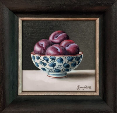 Anne Songhurst Art at Norton Way Gallery Hertfordshire. This beautiful oil painting is an original artwork by British artist Anne Songhurst. It is a still life painting, depicting four plums in a blue and white Japanese bowl. It is framed in a dark wood frame.