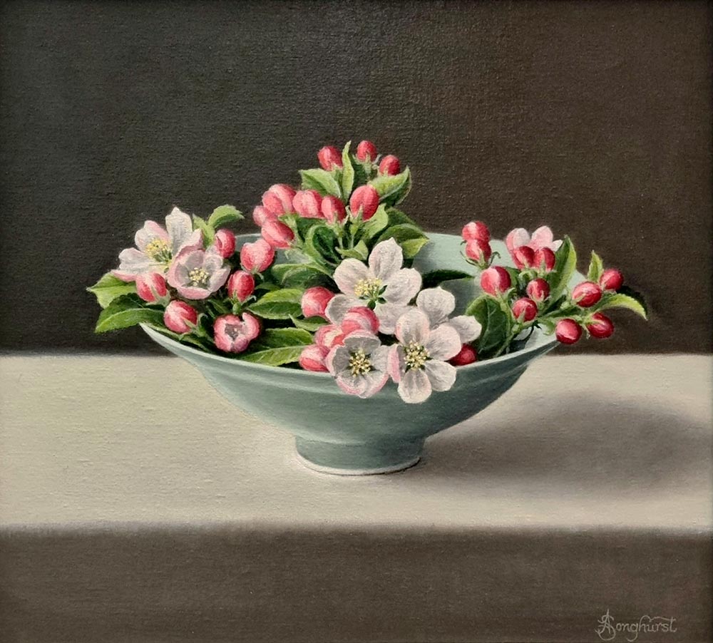 Anne Songhurst Art at Norton Way Gallery Hertfordshire. This beautiful oil painting is an original artwork by British artist Anne Songhurst. It is a still life painting, depicting Apple Blossom in a light blue porcelain bowl. It is framed in a light, off white, painted, wood frame.