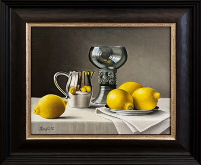 Anne Songhurst Art at Norton Way Gallery Hertfordshire. This beautiful oil painting is an original artwork by British artist Anne Songhurst. It is a still life painting, with lemons and silver and glassware. It is framed in a dark wood frame.