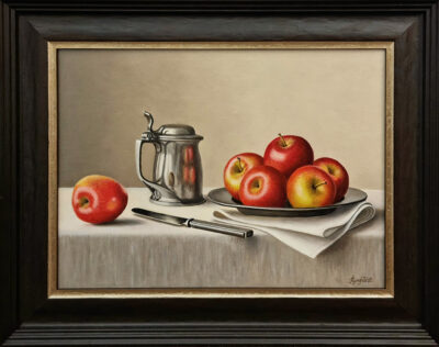 Anne Songhurst Art at Norton Way Gallery Hertfordshire. This beautiful oil painting is an original artwork by British artist Anne Songhurst. It is a still life painting, depicting several rosy red apples piled on a pewter plate. This is accompanied by a pewter knife and jug. It is framed in a dark wood frame.