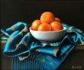 This beautiful Anne Songhurst, original oil painting is exhibited at Norton Way Gallery. It depicts a beautiful blue silk scarf with some vibrant clementines, in a pleasing composition and is typical of an Anne Songhurst realist painting. It is exhibited at Norton Way Gallery Hertfordshire.