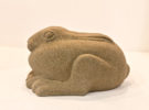 Jennifer Tetlow sculpture at Norton Way Gallery Hertfordshire. This beautiful stone carving, from Jennifer Tetlow is carved from Yourkstone. It depicts a symbolic, beautiful small hare or leveret, huddled down .