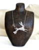 Lou Shotter at Norton Way Gallery, Hertfordshire. This original artwork by British artist, Lou Shotter is created in Stirling Silver. It is a pendant depicting a silver hare. A piece of jewellery.